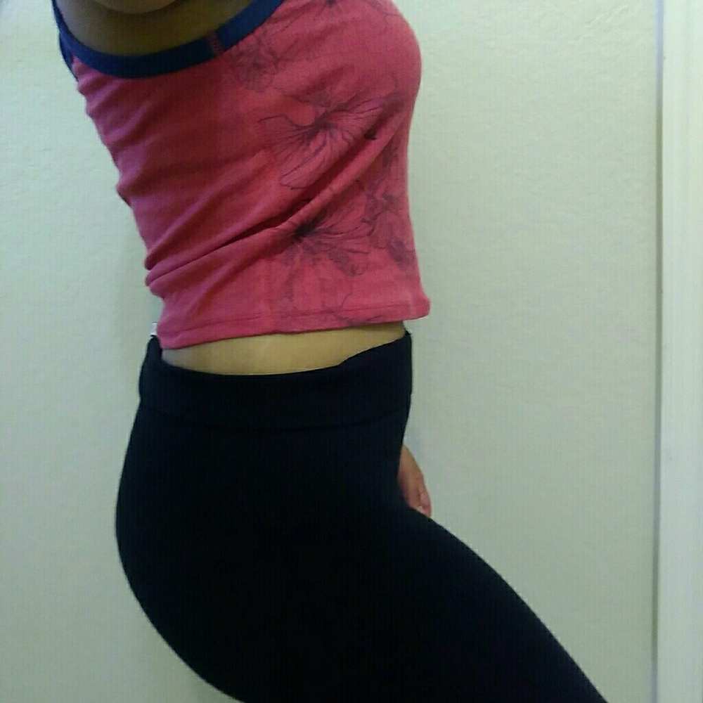 Pink crop top with Hawaii looking flowers in it.